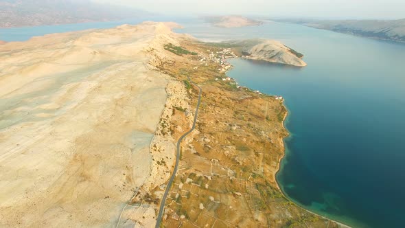 Flying above desert island of Pag at sunset, Croatia