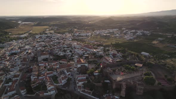 Castle and fortified walled medieval city of Silves, Algarve at sunset. Aerial view