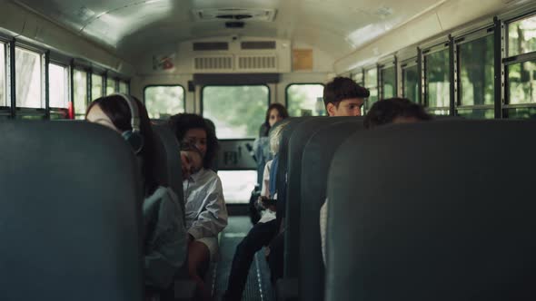 Diverse Students Sitting Schoolbus Together