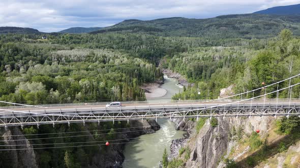 4k aerial footage filmed in 30fps approaching and flying over an old Canyon bridge in remote British