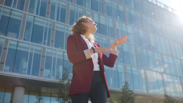 Pretty Businesswoman Dancing with Joy Celebrating Success Outdoors