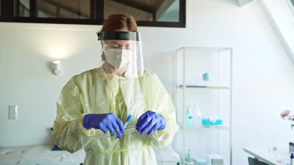 Healthcare worker putting nasal swab in plastic bag