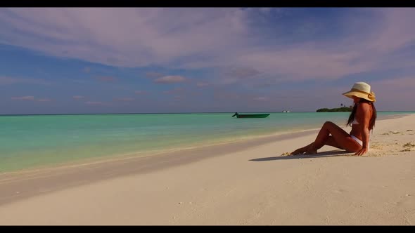 Tourist happy and smiling on relaxing coast beach holiday by blue ocean and bright sand background o