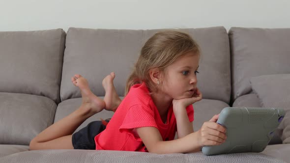 Cute Child Entertaining With Tablet