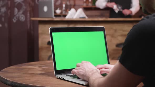 Man Typing Fast on a Laptop with Green Screen