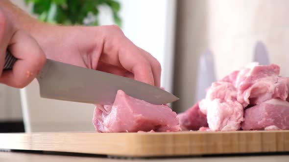 Man Cuts Meat with Knife on Wooden Board Preparation Minced Beef Pork for Cutlets Meatballs Chops