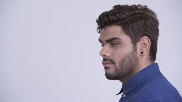 Closeup Profile View of Happy Young Bearded Indian Businessman Looking at Camera