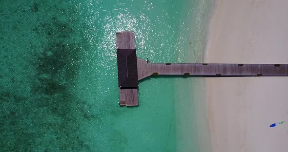 Luxury overhead abstract view of a white sandy paradise beach and blue sea background in vibrant 4K