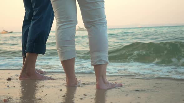 Barefoot man and woman on the beach