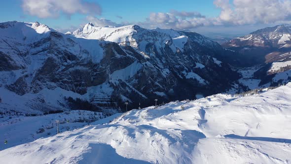 Flight Over Snowcapped Mountains in the Swiss Alps on a Winter's Day