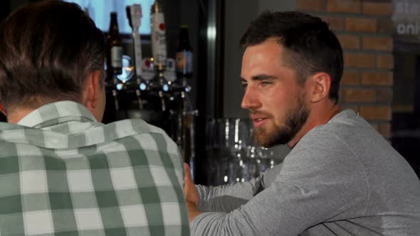 Two Friends Chatting Over Beer at the Local Pub