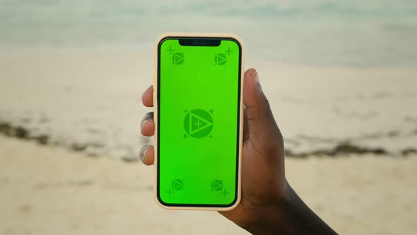 Man Hand Hold White Mobile Phone with Beautiful Fresh Sea and Blue Sky in the Background