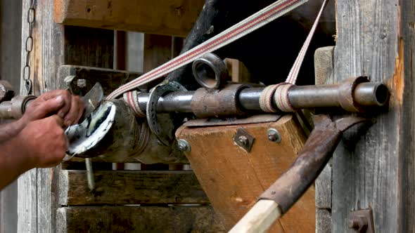 Blacksmith Trimming Horse Hoof with a Cutting Knife