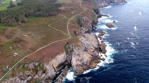 Aerial drone shot of a narrow path over an area called paper cliffs with steep cliffs in Morás, Xove