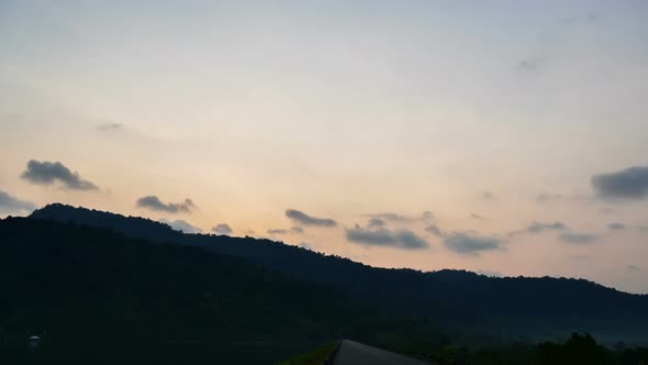 Time lapse sunset sunrise and beautiful twilight fluffy storm cloudy blue and yellow sky