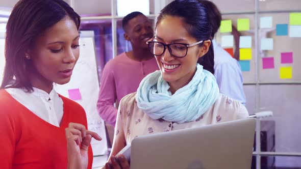 Female business executive discussing over digital tablet