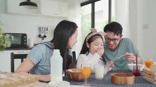 Happiness Asian Japanese family  breakfast at home. young parent and daughter eat