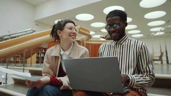 Multiethnic Students Working on Project in Library