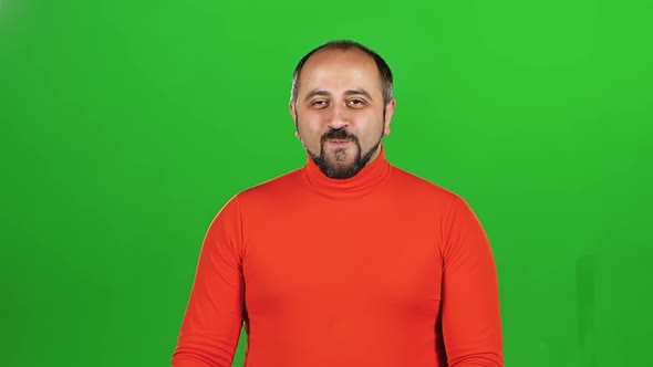 Full Caucasian Man Looking at Camera and Flirting Smiling. Green Screen. Slow Motion