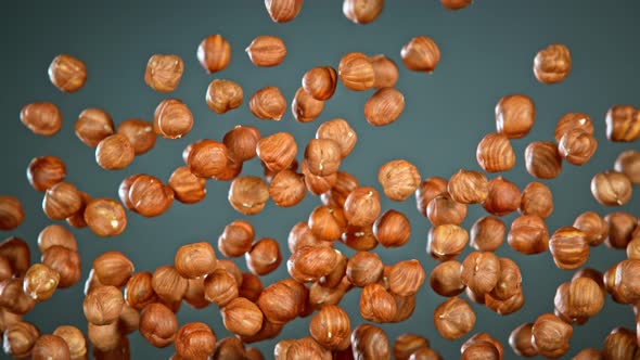 Super Slow Motion Shot of Flying Hazelnuts After Being Exploded on Grey Background at 1000 Fps