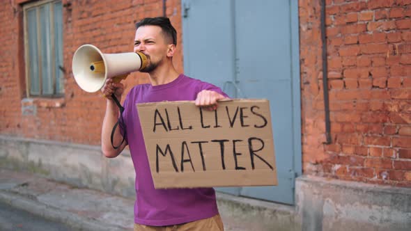 Caucasian Man are Protesting in the Street with Megaphones and Signs