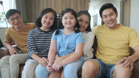 Asian happy big family smiling and watching conversation together cozy room