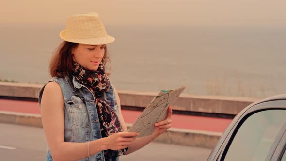 Woman Traveler in Hat with and Map