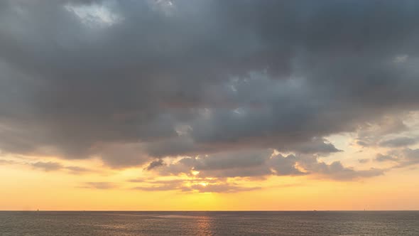 Time Lapse Clouds Moving In Yellow Sky At Sunset.