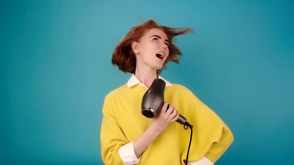 Lady in Yellow Sings Into Hairdryer