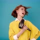 Lady in Yellow Sings Into Hairdryer - VideoHive Item for Sale