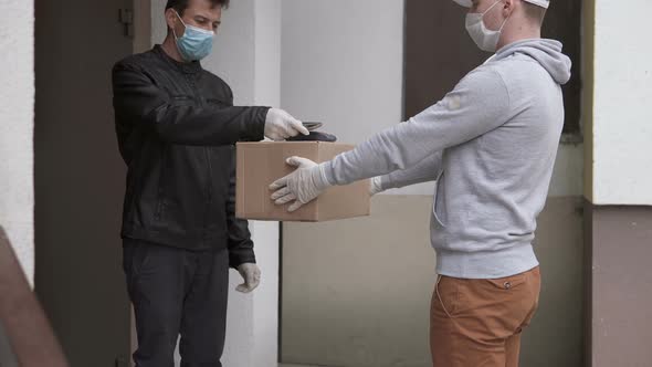 Parcel delivery during a pandemic. Payment via POS-wireless terminal with a card or smartphone