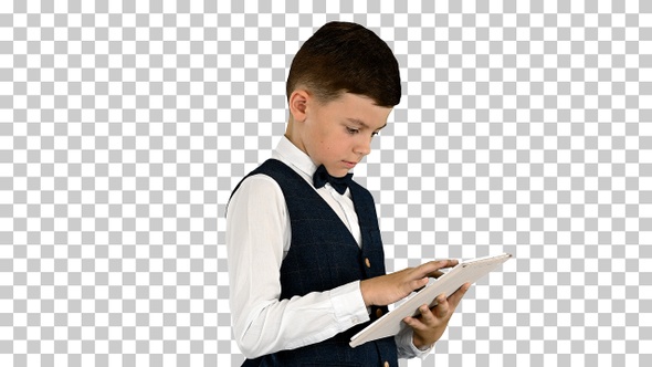 Concentrated boy using digital tablet while standing, Alpha Channel