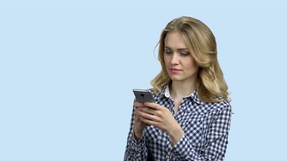 Young Happy Woman Typing Text Message on Phone