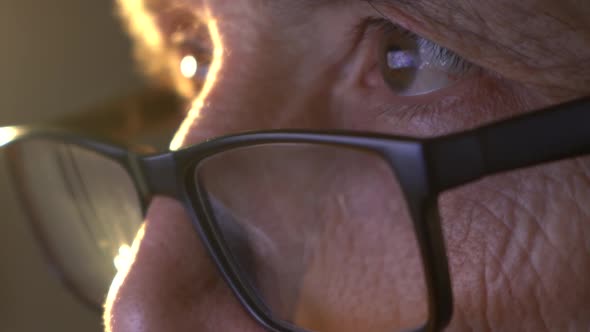 Closeup of the Focused Eyes of a Businessman Wearing Computer Glasses