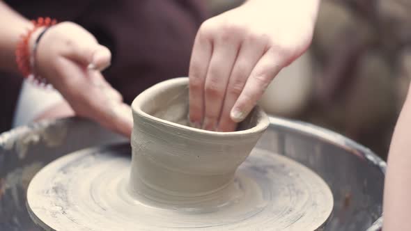 Close Up Hands Make Pitchers in Pottery