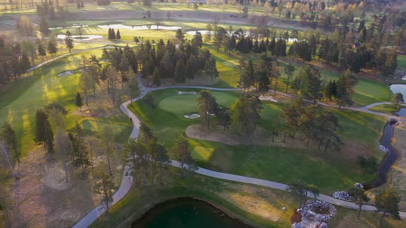 Flying over lakes, trees and countryside on a spring morning