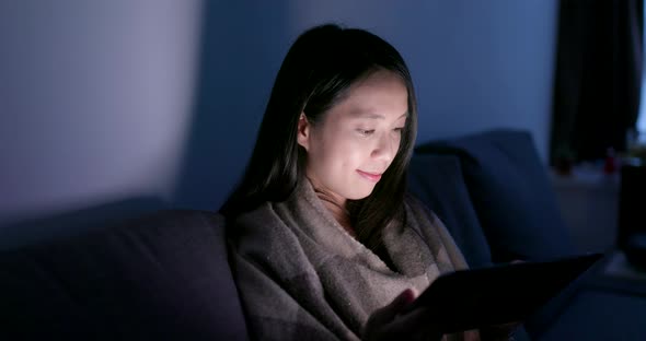 Woman use of smart phone in the evening at home