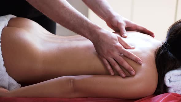 Closeup of Process of Doing Back Massage for Client in Massage Salon