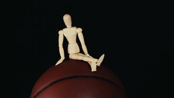 footage of basketball wooden figure dark background
