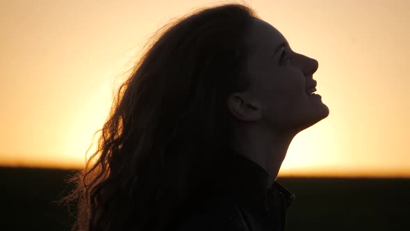 silhouette of a happy woman face on a sunset