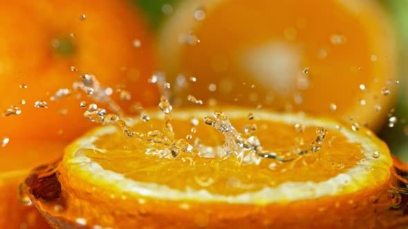 Super Slow Motion Shot of Water Splashing on Fresh Orange at 1000Fps