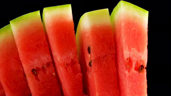 Ripe Juicy Natural Watermelon, Sliced Red Watermelon Swirls On A Black Background.