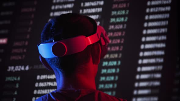 Trader in a Virtual Reality Helmet Looks at Cryptocurrency Charts