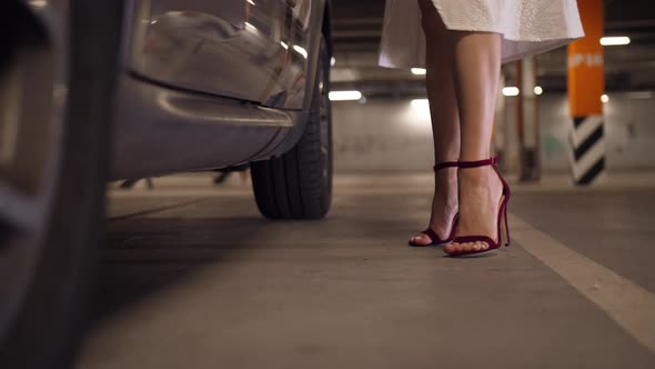 Woman's Feet in High Heeled Shoes Getting in Car