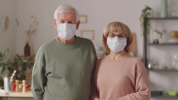 Portrait of Senior Couple in Protective Masks at Home
