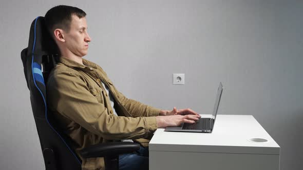 Young Freelancer Feels Uncomfortable Fidgeting in Armchair