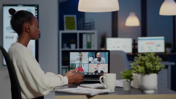 African Businesswoman Talking During Video Conference with Team