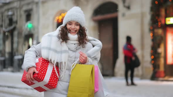 A Woman is Going to the City Center During a Snowfall