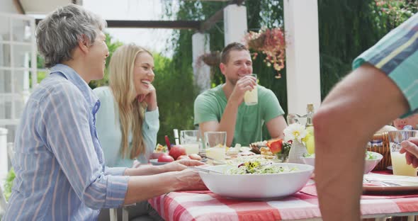 Happy family eating together at table