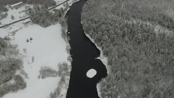 Iceberg in middle of Piscataquis river. Maine. USA. Aerial tilt down